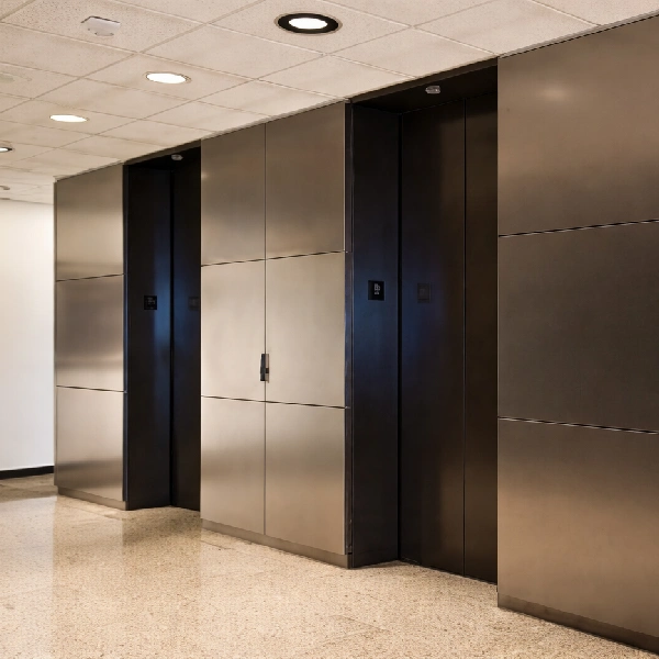 Modern elevator lobby featuring sleek, brushed metal wall panels