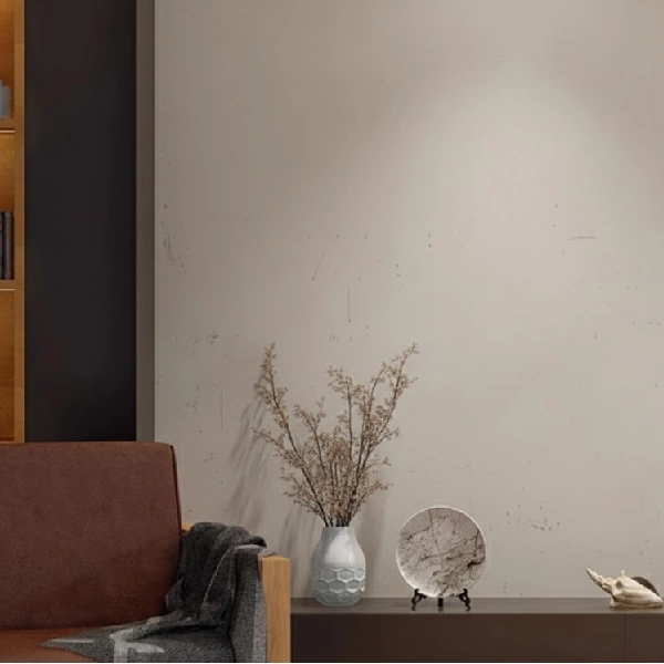Plain unfinished wall featuring a brown chair