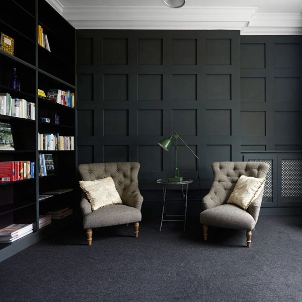 Wall Panel In Studyroom.webp Black square grid wood wall paneling in a study.