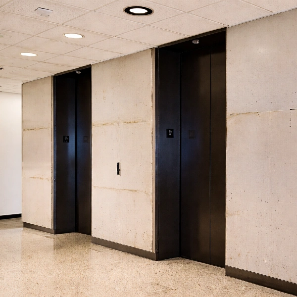 elevator lobby featuring raw, light-colored before wall panels installation